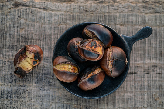 roasted chestnuts on wooden table