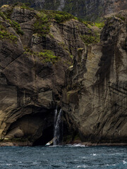 Galo Cave waterfall, with a mossy cliff. Flores Island.