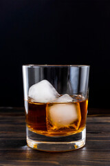 Glass of whiskey on dark wooden table, isolated with black background. Generative AI