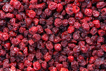 Dry red pitted cherries in the background, closeup, top view. A way to preserve vitamins....