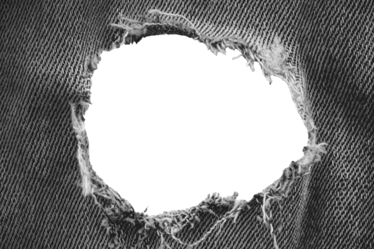 Hole in denim on a white background. Ripped jeans