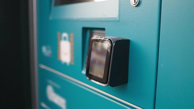 Luggage storage. Automated self service post terminal machine or locker to receive a parcel or to deposit the luggage for storage. Numbered storage box in public place. Cells with metal locks, key