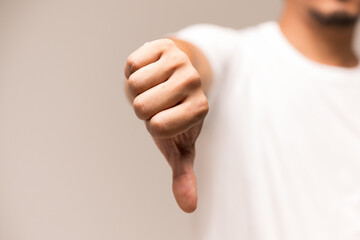 Man's thumbs down isolated on white background.Dislike sign finger and hand.Bad idea concept. - obrazy, fototapety, plakaty