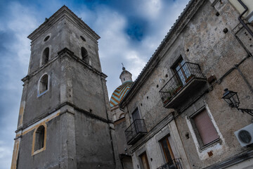 Fototapeta na wymiar Italian town church dome seeing through the buildings