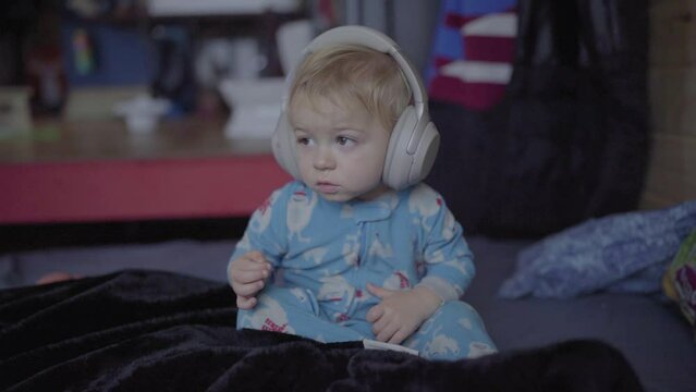 Cute Blond Boy Listening Music Through Headphones At Home - Fairbanks, Alaska