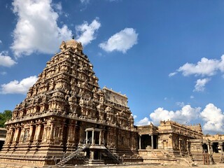 Tower of Airavatesvara Temple, Darasuram, Kumbakonam, Tamilnadu. Hindu temple gopuram with blue sky cloudy background.