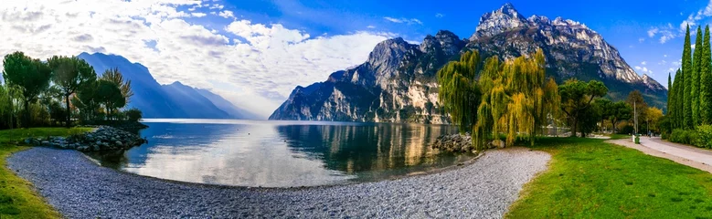 Poster Italy travel ,scenic Garda lake , Trento province.  Lago di Garda. Wonderful autumn scenery. sunny morning in Riva del Garda. © Freesurf