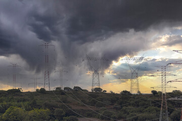 Electrical power lines and tower, stormy sky