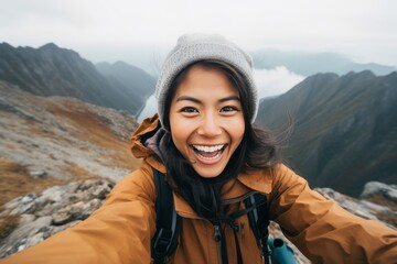 Fototapeta na wymiar An Asian girl with her sweet smile taking a selfie photo on top of a mountain generative ai