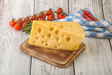 Maasdam cheese piece over board