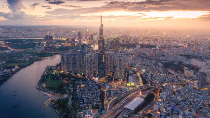 Aerial sunset view at Landmark 81 - it is a super tall skyscraper and Saigon bridge with development buildings along Saigon river, cityscape in the night