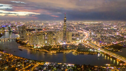Aerial sunset view at Landmark 81 - it is a super tall skyscraper and Saigon bridge with...
