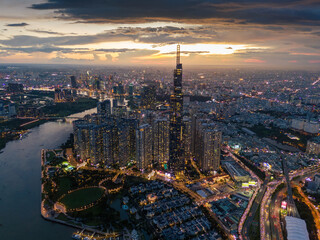 Aerial sunset view at Landmark 81 - it is a super tall skyscraper and Saigon bridge with...
