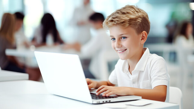 portrait of  caucasian school boy learning at a laptop in the school