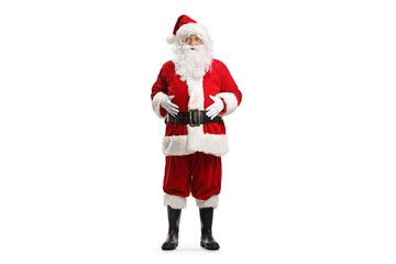 Full length portrait of santa claus standing with hands on his belly