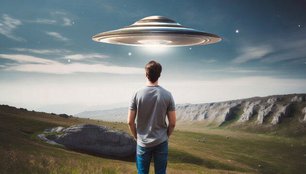back view of man looking at alien invasion ufo flying in the sky concept of evidence and sighting