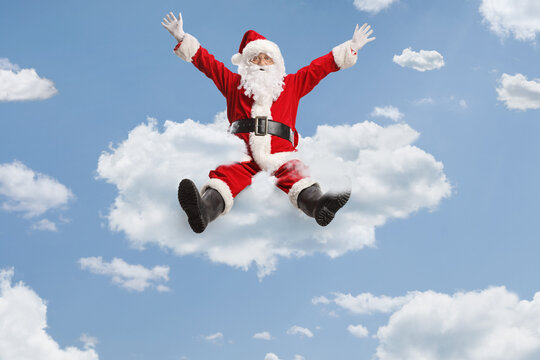 Cheerful santa claus floating on clouds - Powered by Adobe