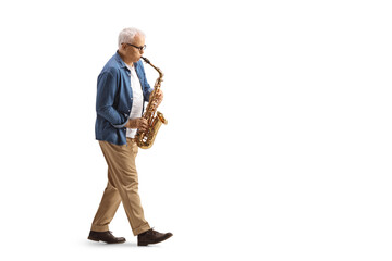 Fototapeta premium Full length profile shot of a mature male musician in casual clothes playing a sax