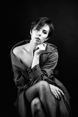 black and white portrait of pretty woman in trench coat