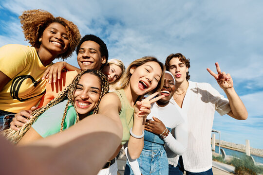 Chinese Woman Taking A Selfie With Multi-ethnic Friends