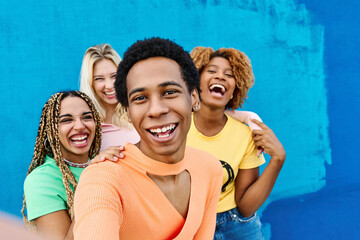 gay man and multi-ethnicfriends taking a selfie