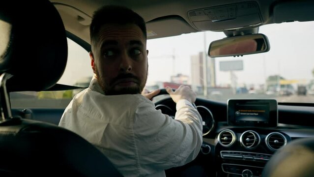 back view a man a businessman is driving a luxury car around the city a black leather interior a navigation screen traffic jams