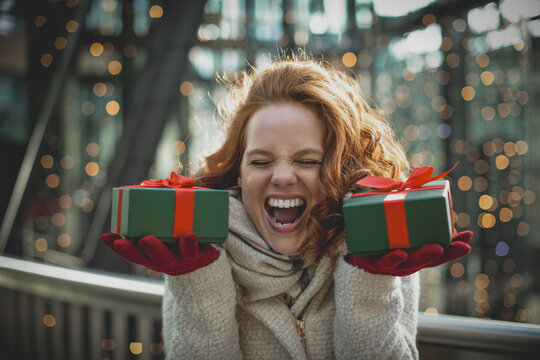 portrait of a redhair smiling woman, person with christmas gift