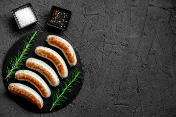 German sausages on the grill on stone background with copy space for your text