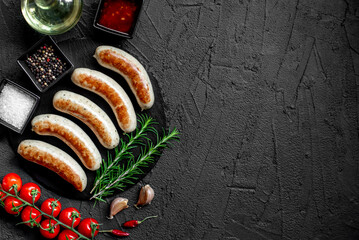 German sausages on the grill on stone background with copy space for your text