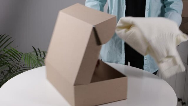 packing clothing in shipping box