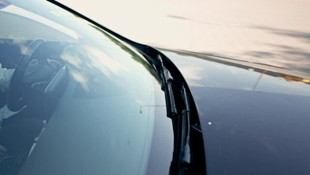 close-up of the windshield of a luxury car with wipers details of auto glass cleaning