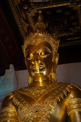 Vertical and close of golden buddha image of Wat Na Phra Men