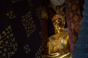 Golden buddha image of Wat Na Phra Men with space and paint on left