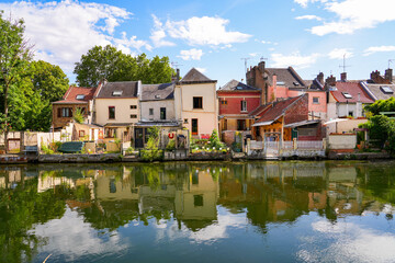 Fototapeta na wymiar Houses built on the banks of the river Somme opposite the famous Hortillonnages of Amiens in Picardy, France