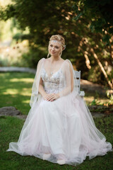 Fototapeta premium portrait of a happy bride in a light light dress in wearing elven accessories