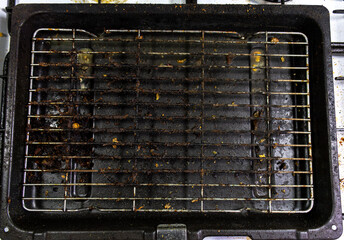 A very dirty and greays grill tray