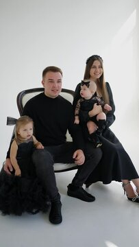 Cheerful family with children in the studio on a photo shoot