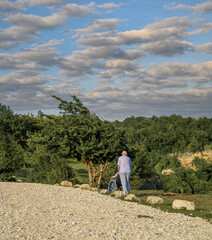 A man takes his son in a wheelchair to see the mountain landscape