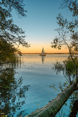 White sailboat on the sunset river