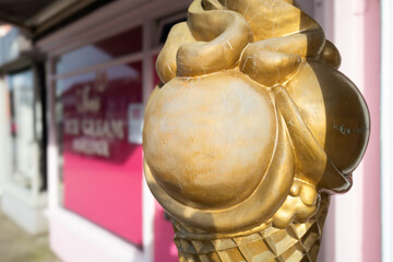Shallow focus of a large plastic ice cream and cone seen outside an English ice cream parlour on England's east coast.