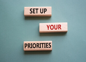 Set up your Priorities symbol. Concept words Set up your Priorities on wooden blocks. Beautiful grey green background. Business concept. Copy space.