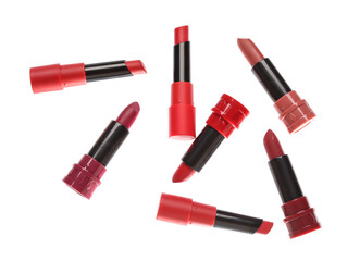 Obraz premium Different bright lipsticks on white background