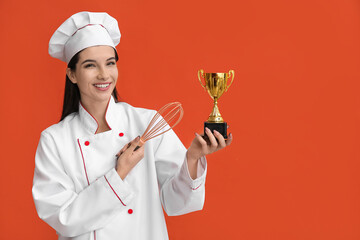 Female chef with gold cup and whisk on orange background