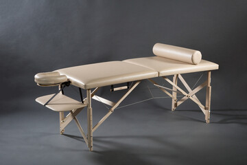 Portable folding massage table for physical therapy treatment room on the dark background