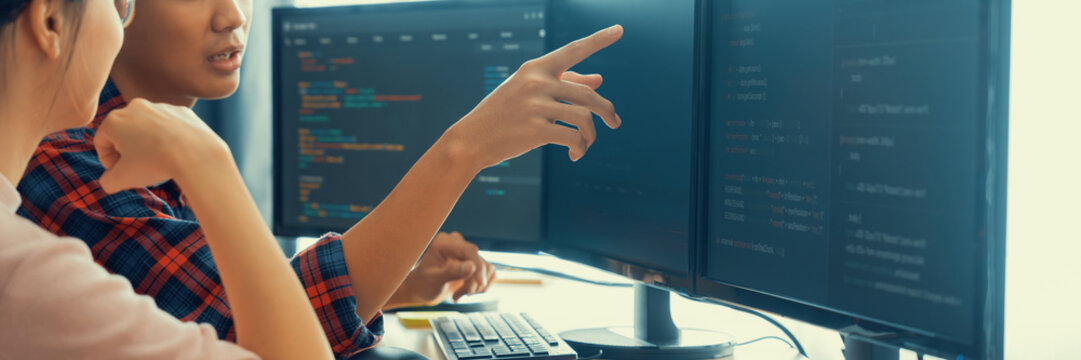 Cropped image of professional programer team collaboration discuss about web coding while coworker point java script displayed on computer at modern company office. Closeup. Burgeoning.