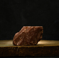 stones on a dark gray background for the podium. stones with texture for product presentation. minimalist background with stones for the podium.