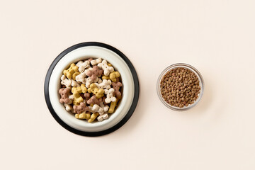 Dry dog vegan vegetarian food concept. Lentils near bowl with pet feed on beige background