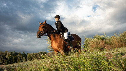 Horsewoman in equestrian sports gear, riding a horse, against an expressive sky, horseback riding...