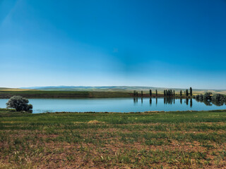 A scenic lake view in the province of Çorum in Turkey. The lake has a peaceful tranquility with the green areas around it.