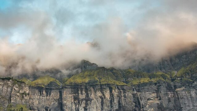 Landscape of Giffre valley of mountain range with cascade and foggy in the evening at Sixt Fer a Cheval, French Alps, France
